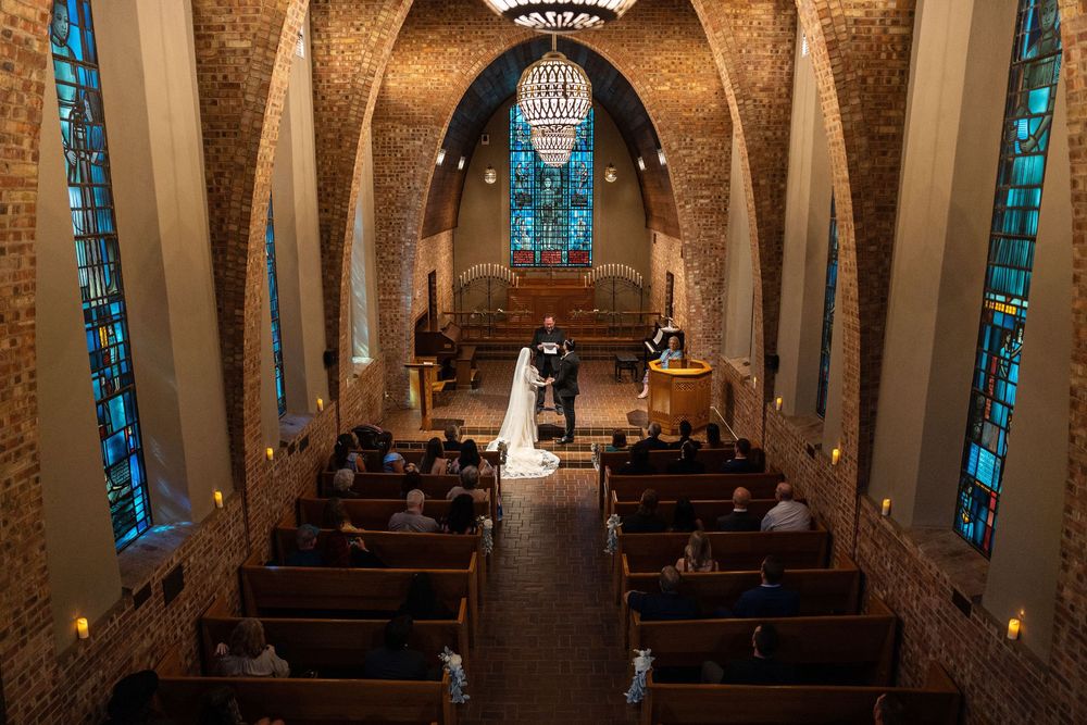 bride and groom at altar inside chapel