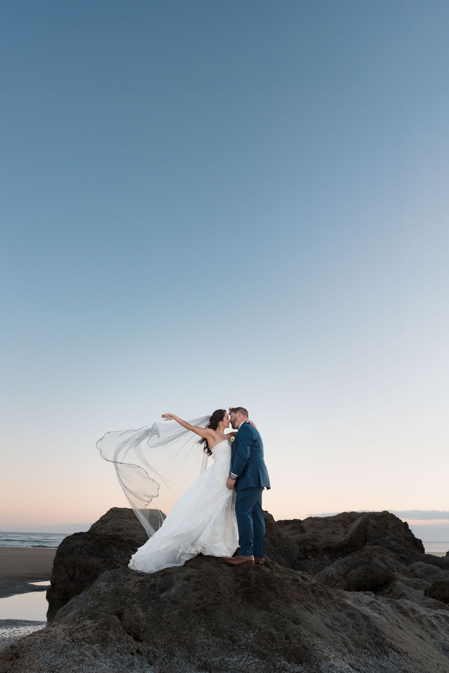 Romantic kiss through vintage car window on wedding day.