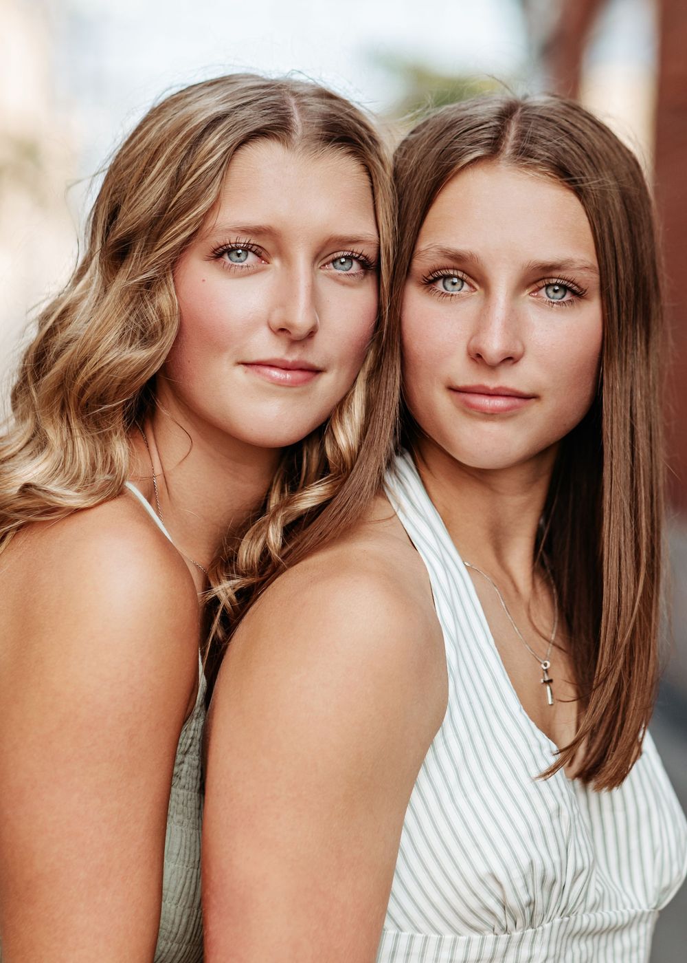 Two friends in white and brown outfits share a close moment while posing together in multiple photos.