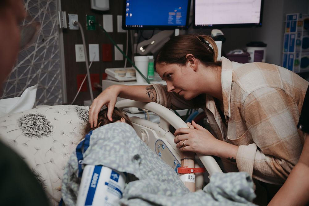 Family supporting laboring mother in hospital.