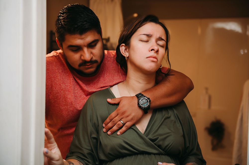 Husband comforting wife in labor