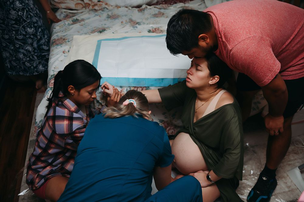 Birth team supporting a mom about to give birth.