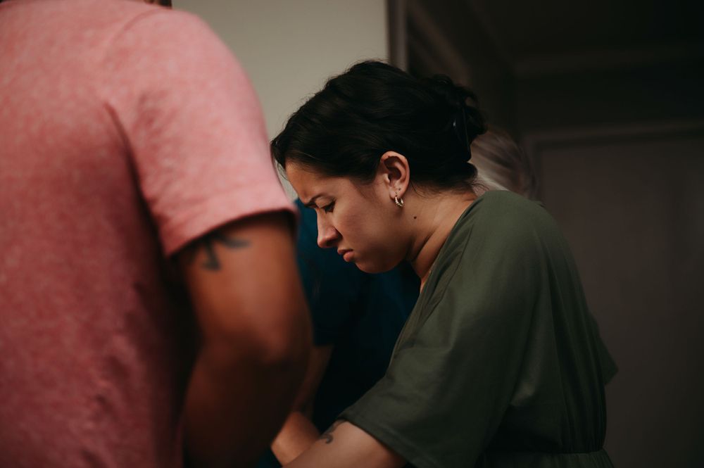 Woman with her midwife about to give birth