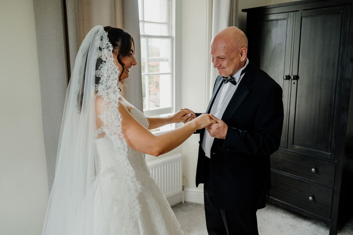 First look with brides dad at The Green wedding venue in Liskeard. Bride in white lace gown and veil