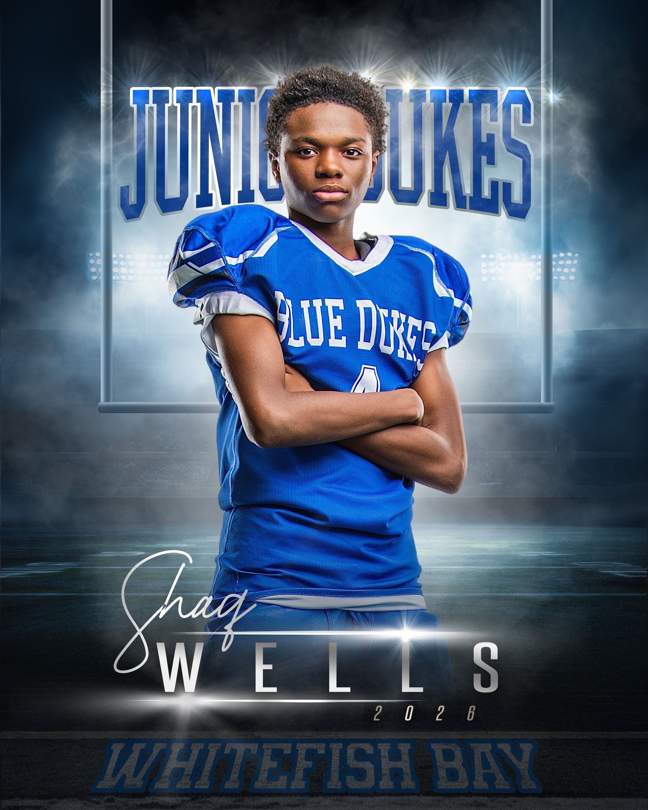Shaq Wells #4 Blue Dukes junior football player poses in uniform with arms crossed for Whitefish Bay 2028 team photo.