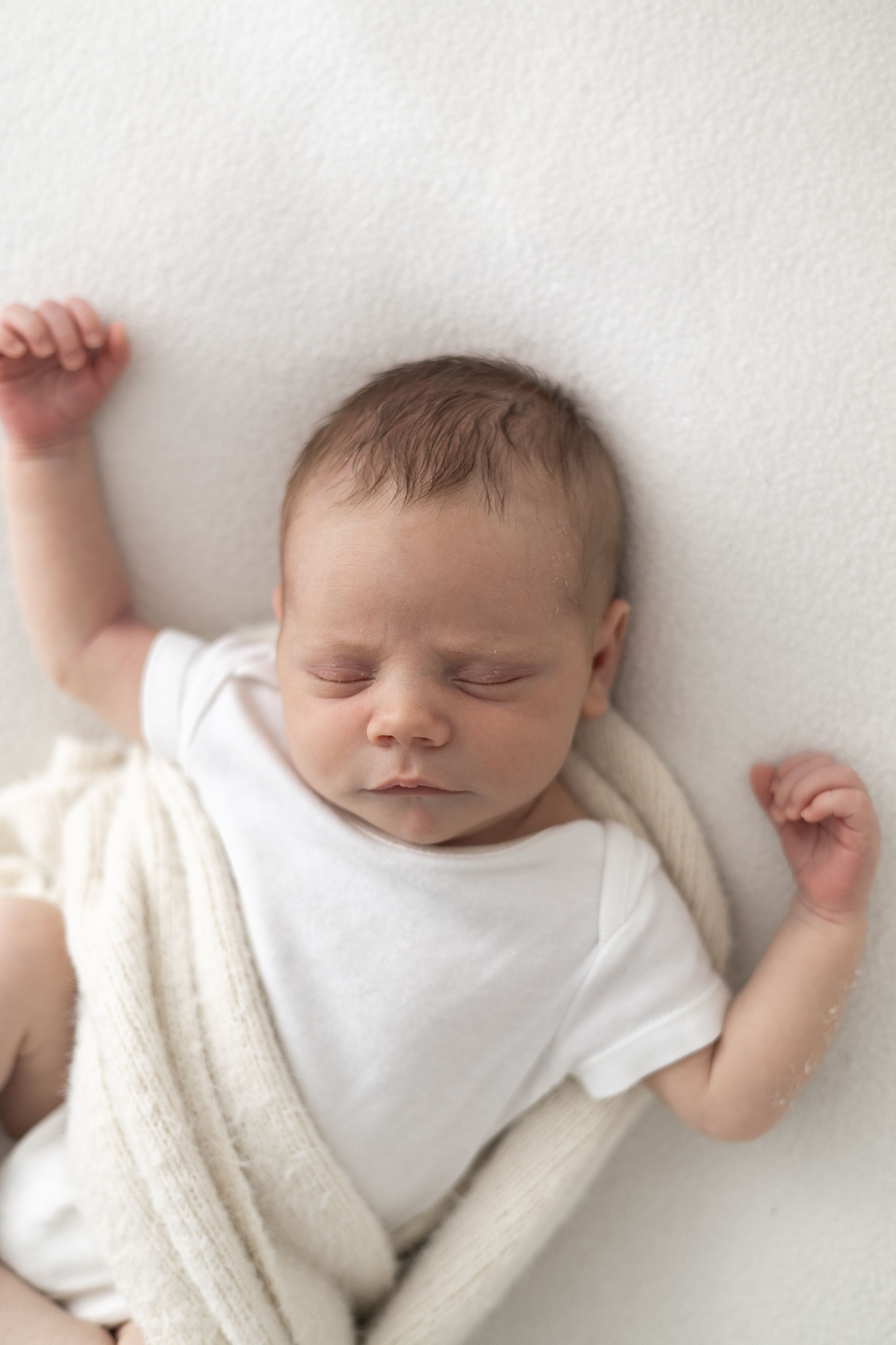 Newborn baby peacefully sleeping during a relaxed natural photography session