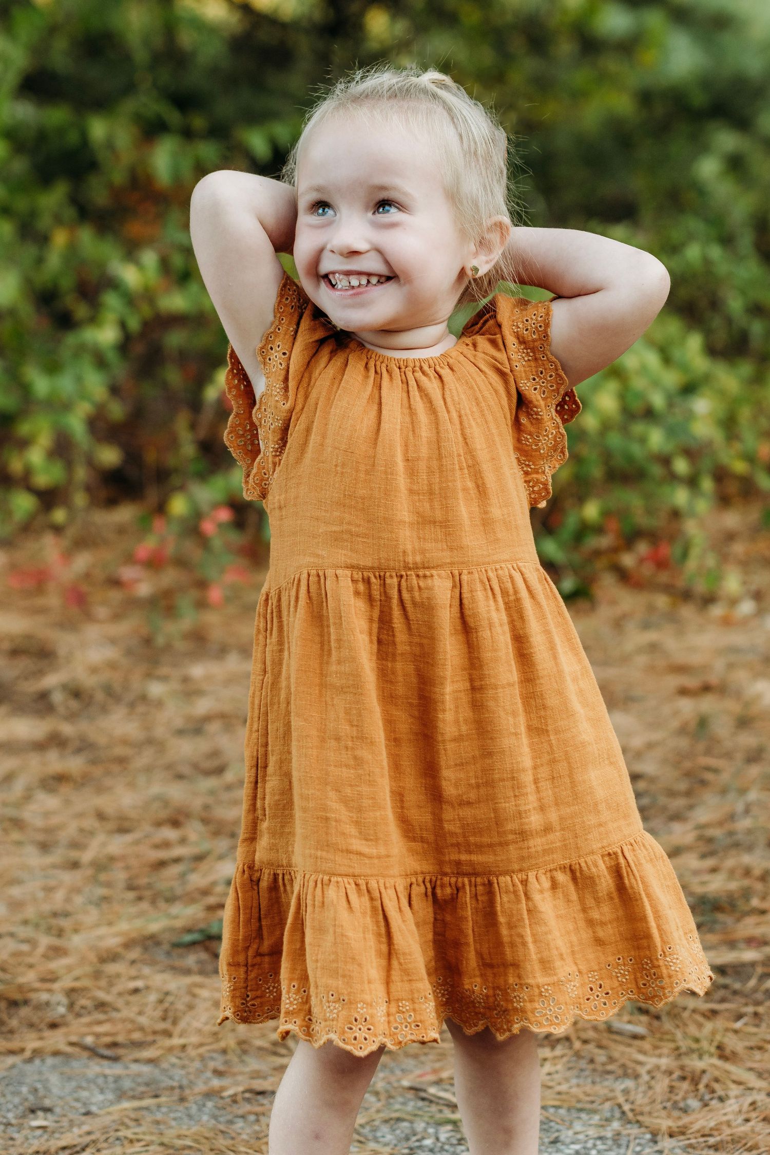 Little girl smiles during a family photography session in Mullica Hill, NJ.