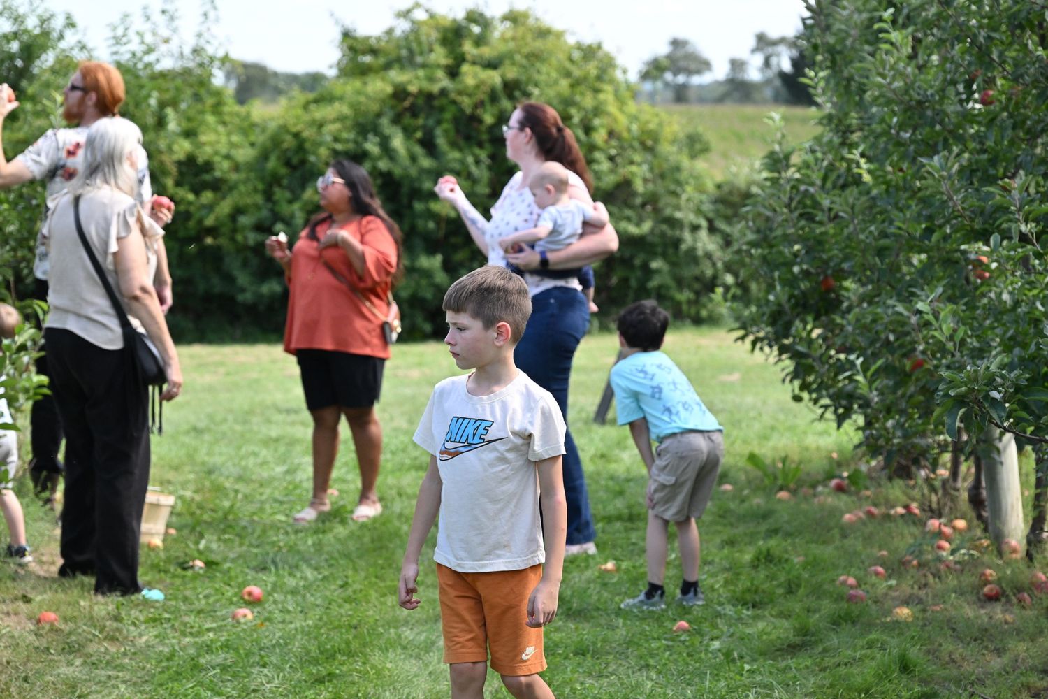 Children exploring outdoors with family during a candid family adventure.