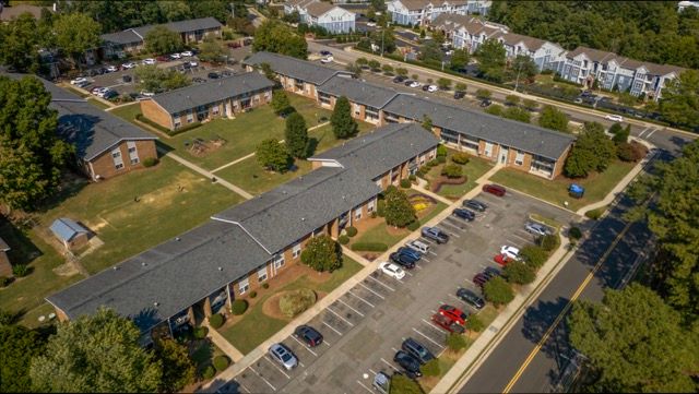 Aerial view of multifamily commercial property showing buildings, parking, access roads, and surrounding development in Durham, NC