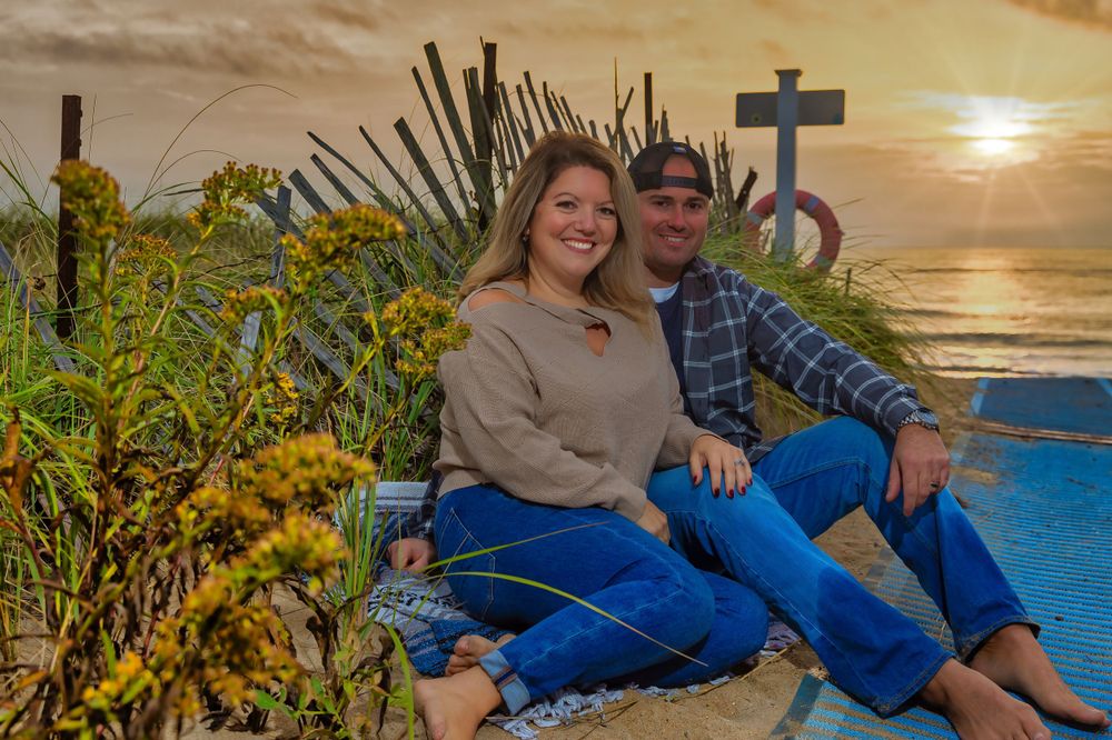 Couple relaxing on coastal terrace during golden hour sunset.
