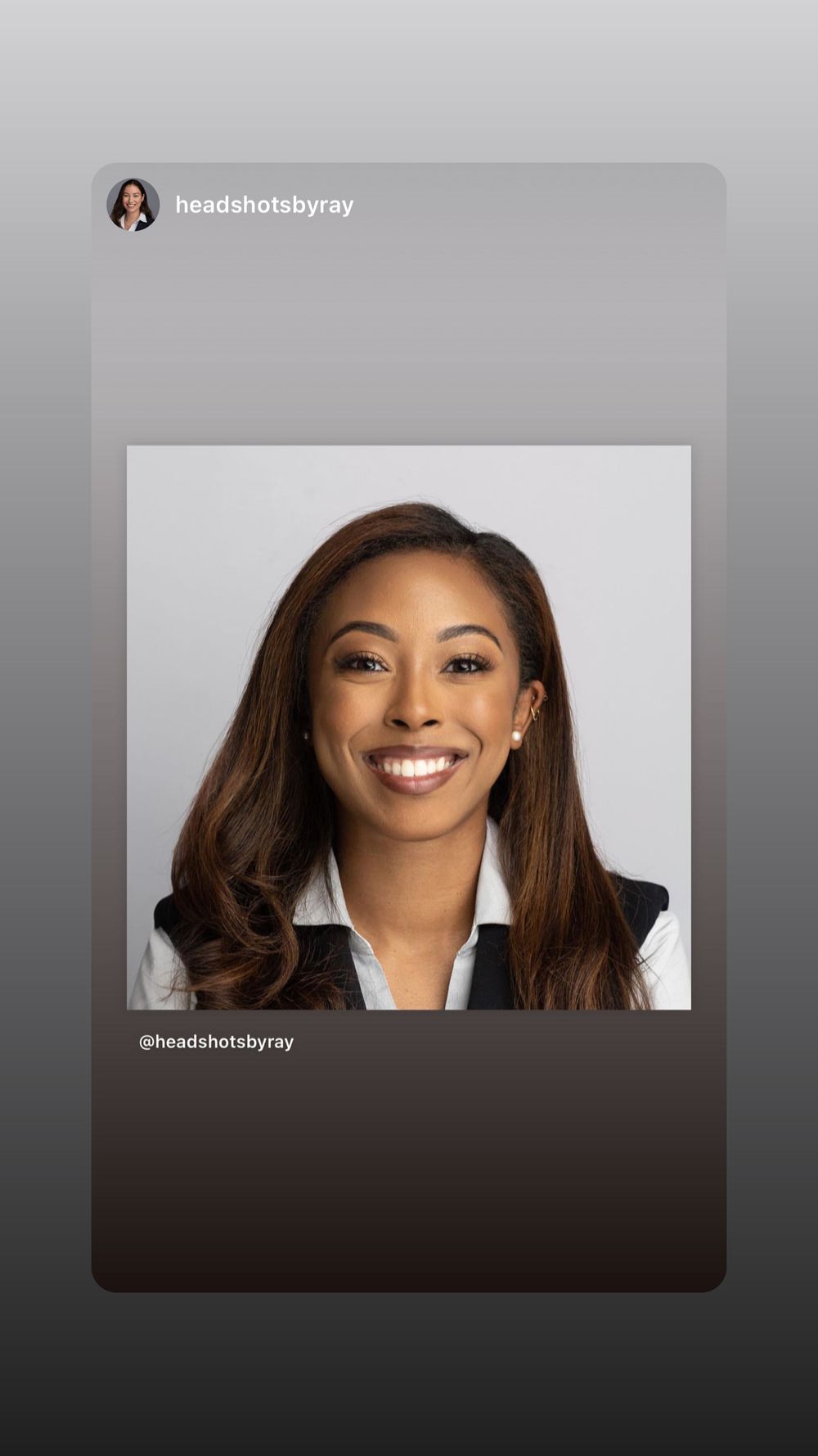 Professional headshot of a smiling Black woman with long brown hair wearing a white shirt and dark blazer.