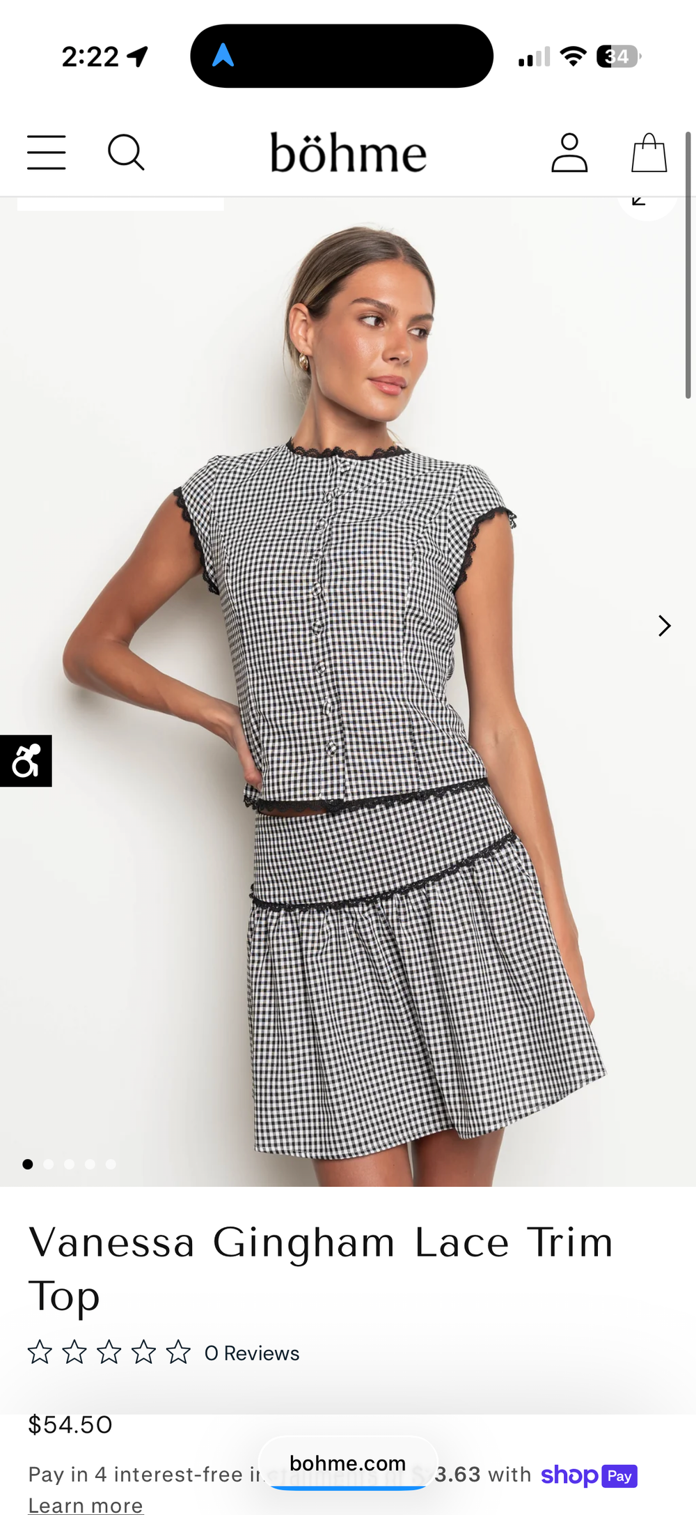 Woman wearing a black and white gingham lace trim crop top paired with a matching mini skirt from Bohme.