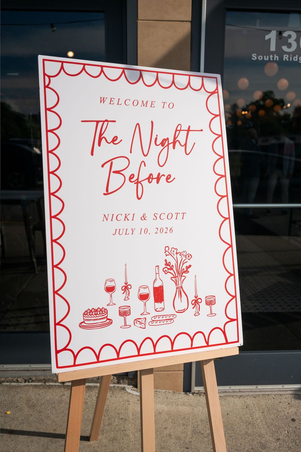Welcome sign for The Night Before rehearsal dinner for Nicki & Scott, July 10, 2026, with red scalloped border.