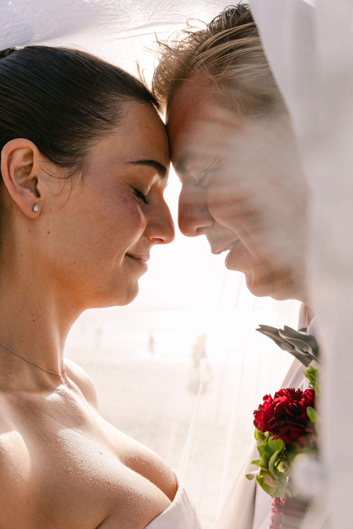 Bride and groom sharing an intimate forehead touch during their romantic Byron Bay wedding portraits.