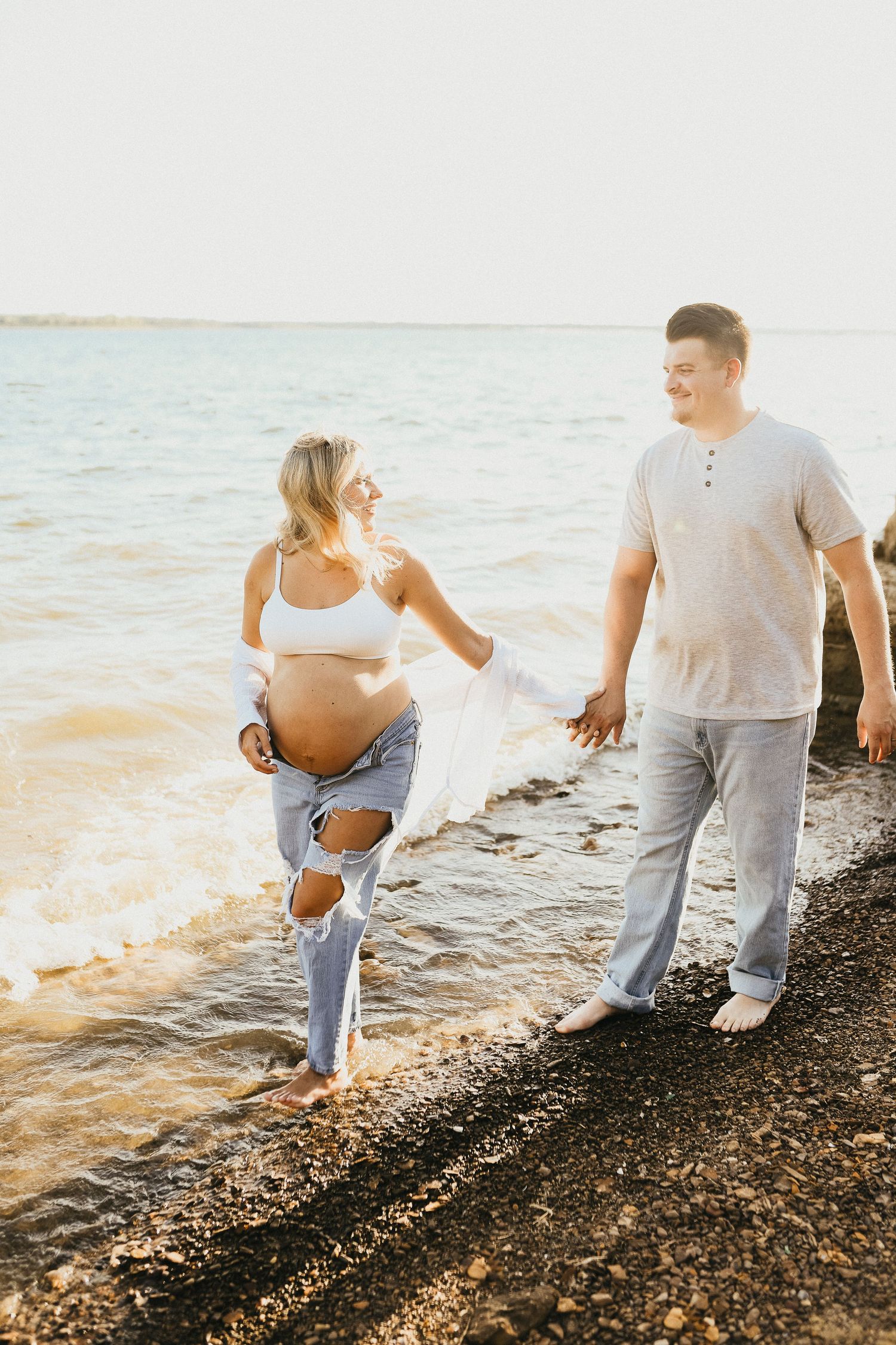 Expecting couple walking together during their Lake Grapevine maternity session