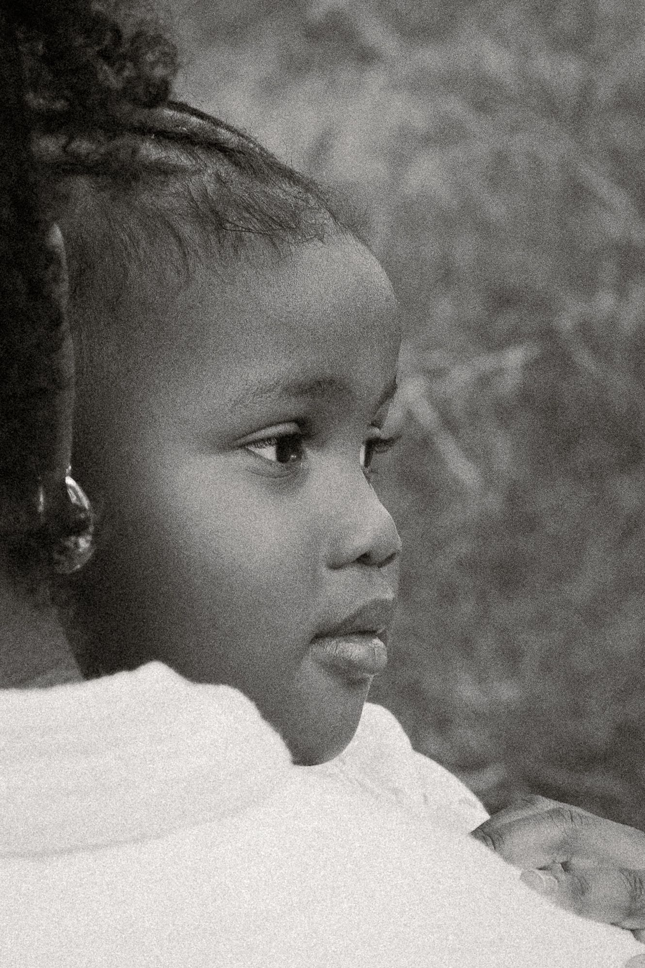 Black and white portrait of a young African girl in profile view, wearing a white top and small earring at Papago Park in Phoenix
