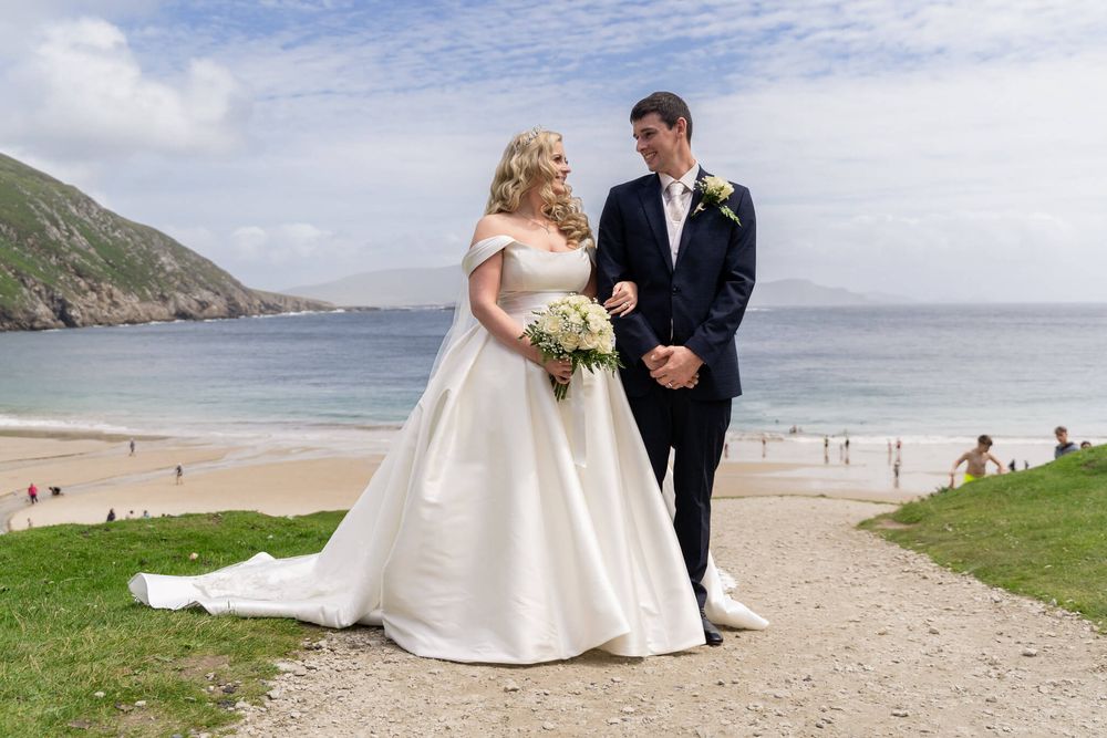 Bride and Groom posing at the beach , Achill Island Co Mayo photo by AK wedding photography and videography.