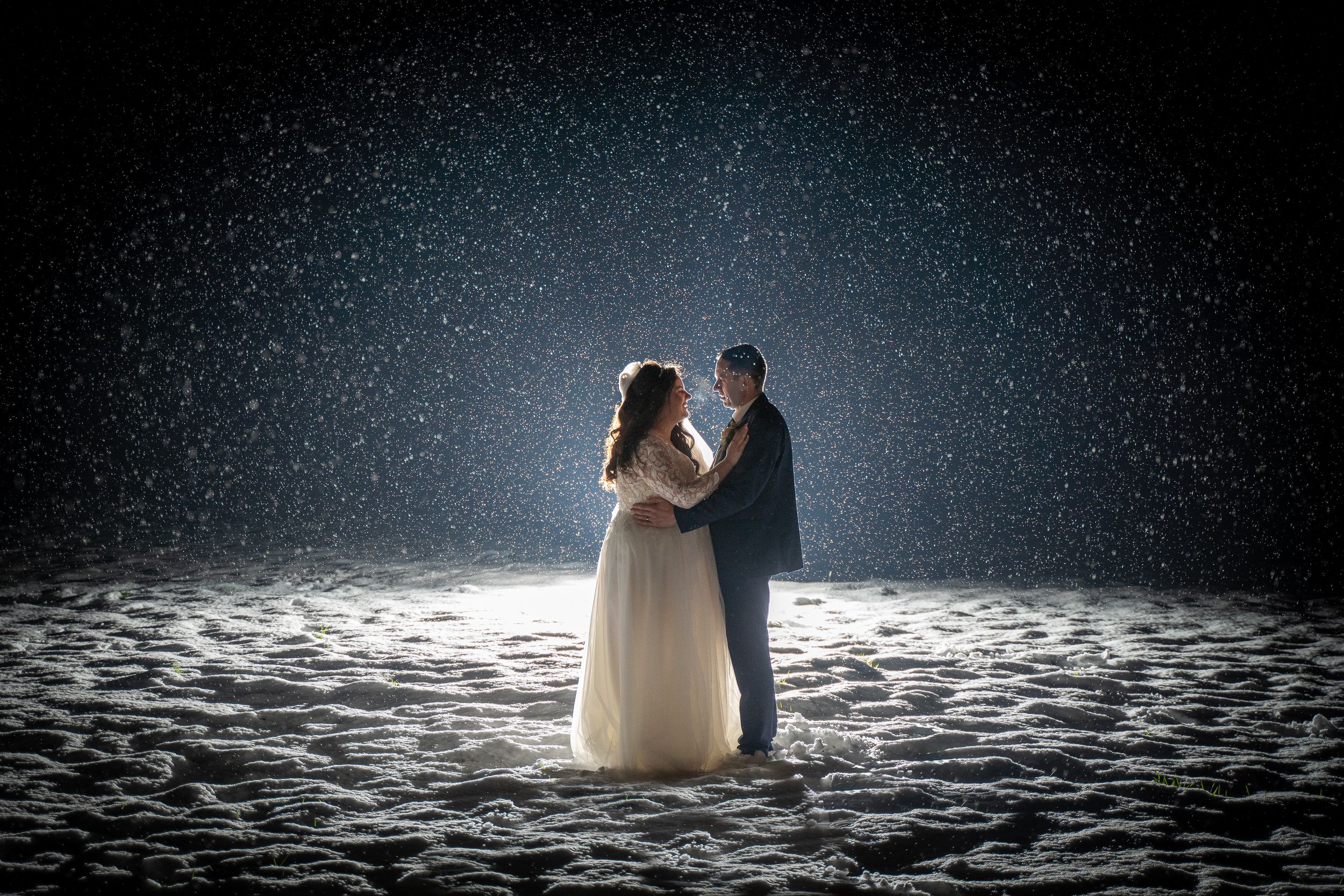Wedding Couple dancing romantically in the snow at night at Breaffy house hotel wedding photo by AK wedding photography and videography