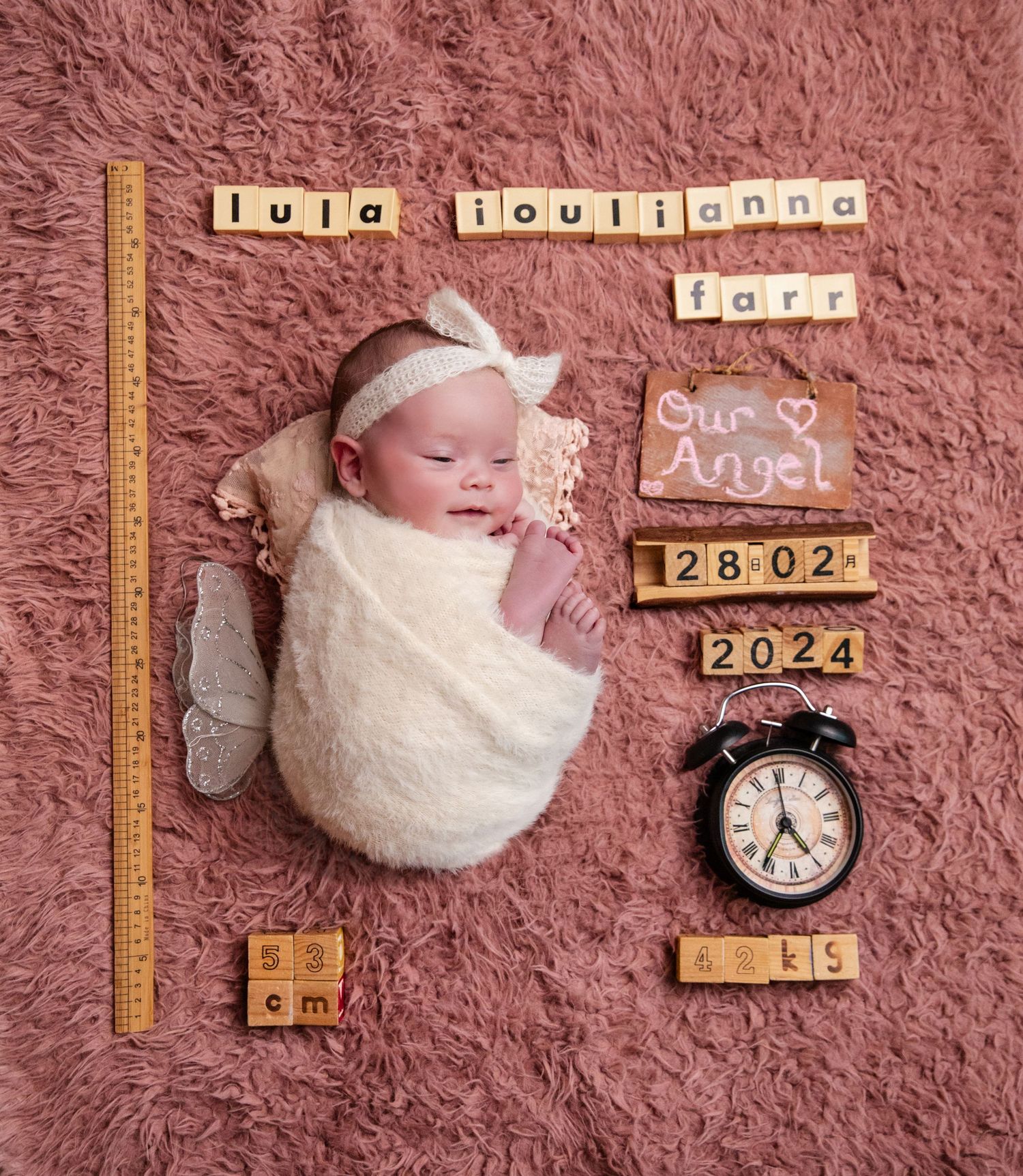 Newborn baby girl Lula Joulianna Farr swaddled on pink fur, birth announcement with date 28.02.2024, weight, and clock.