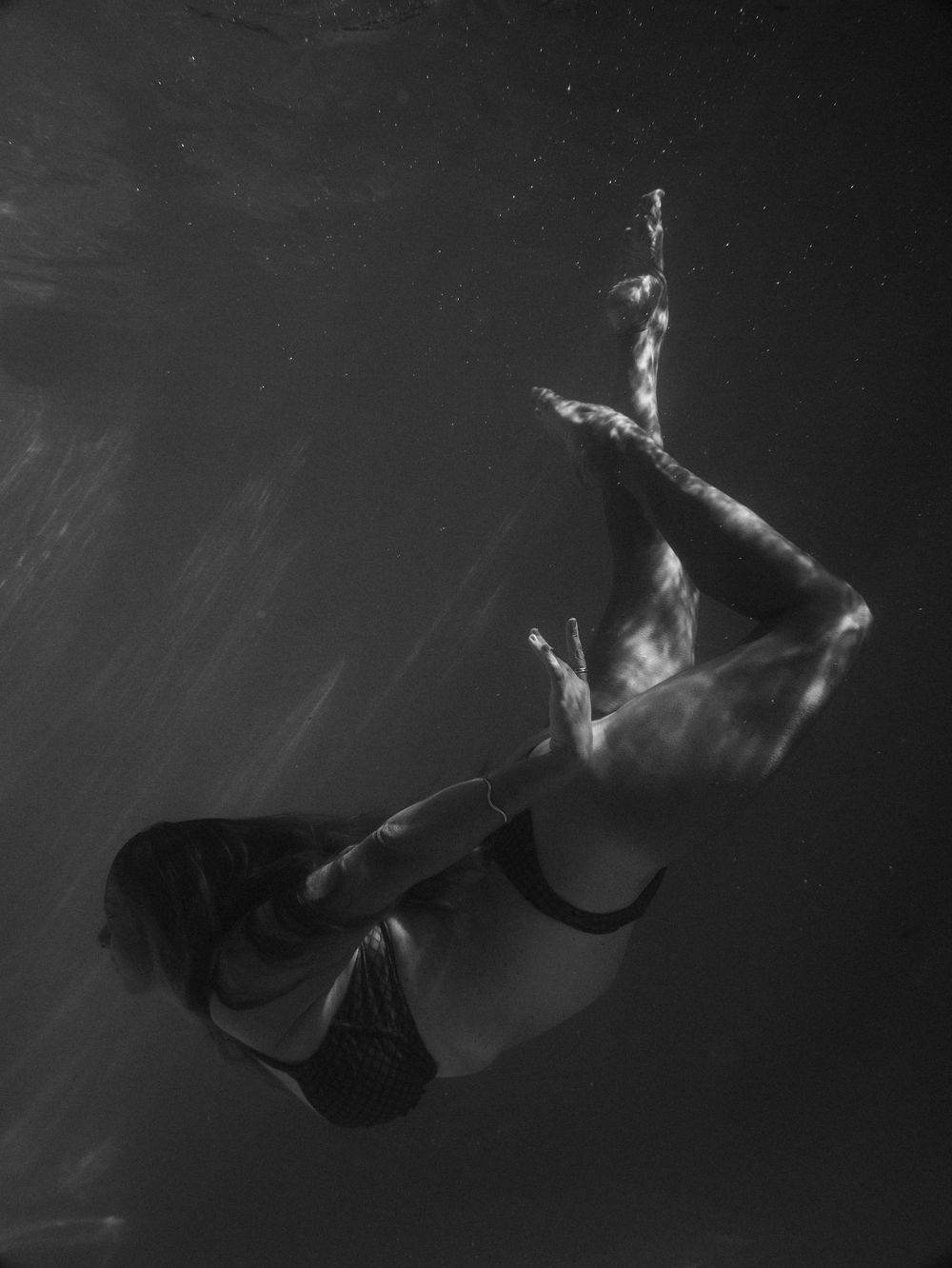 black and white portrait of a woman dancing underwater on a pool session at Lake Macquarie, NSW