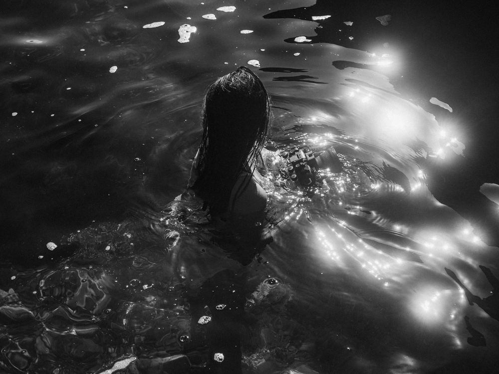woman photographer with underwater camera posing for a unique headshot in her element on The Tide of Her portrait session coastal NSW