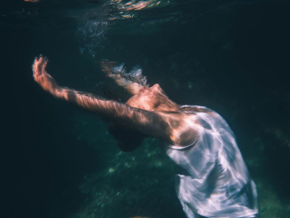woman allowing the water to move her body with gravity in an empowering portrait session The Tide of Her in Lake Macquarie NSW