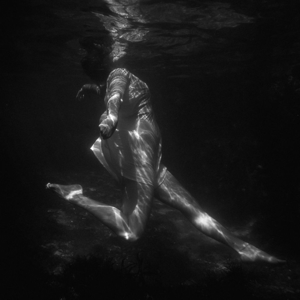 woman striking a pose underwater with head above water for her first pose in Tide of Her underwater portrait session coastal NSW