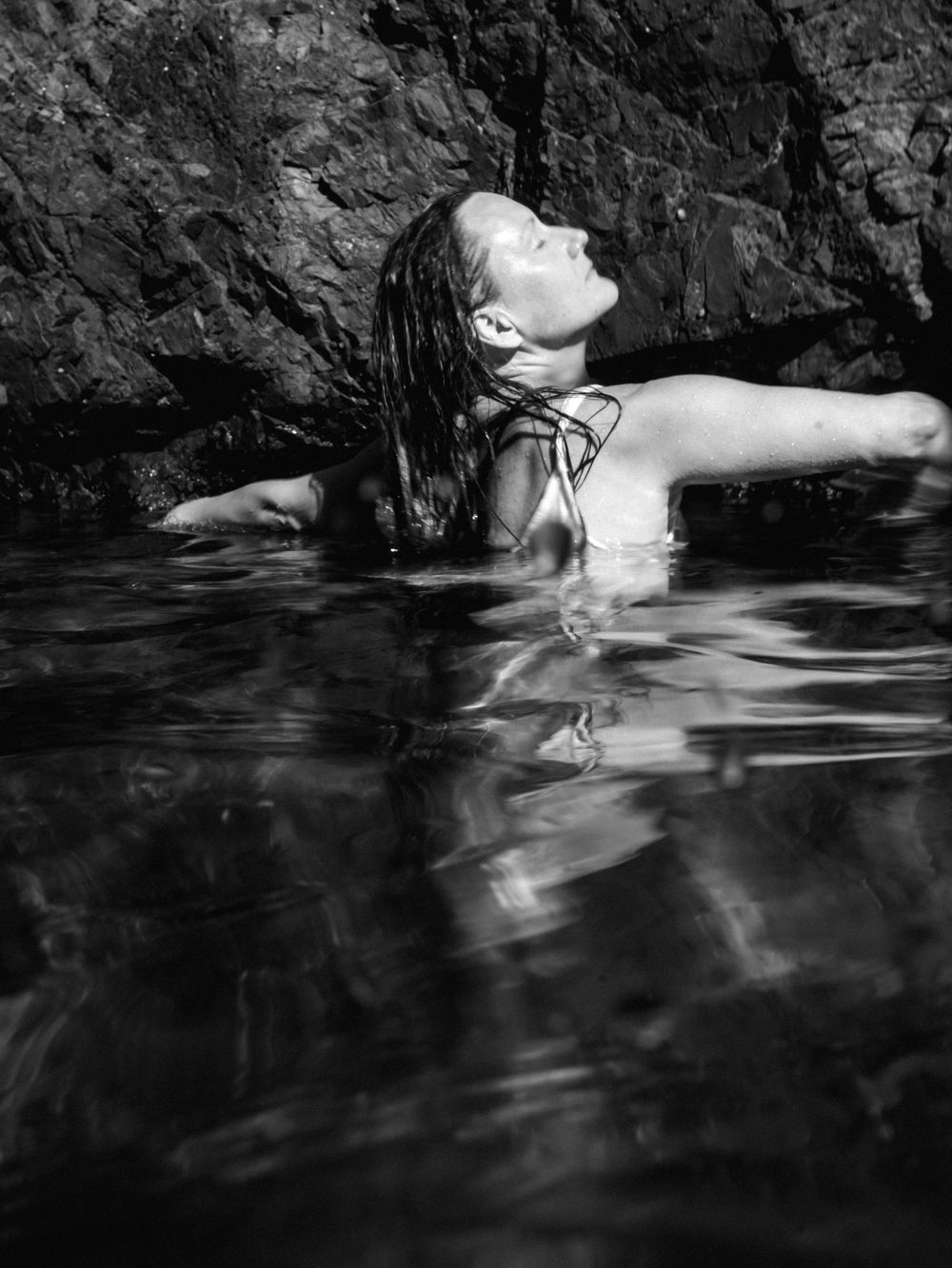 portrait of a woman in black and white in anticipation of opening arms wide to dance freely in the ocean in NSW