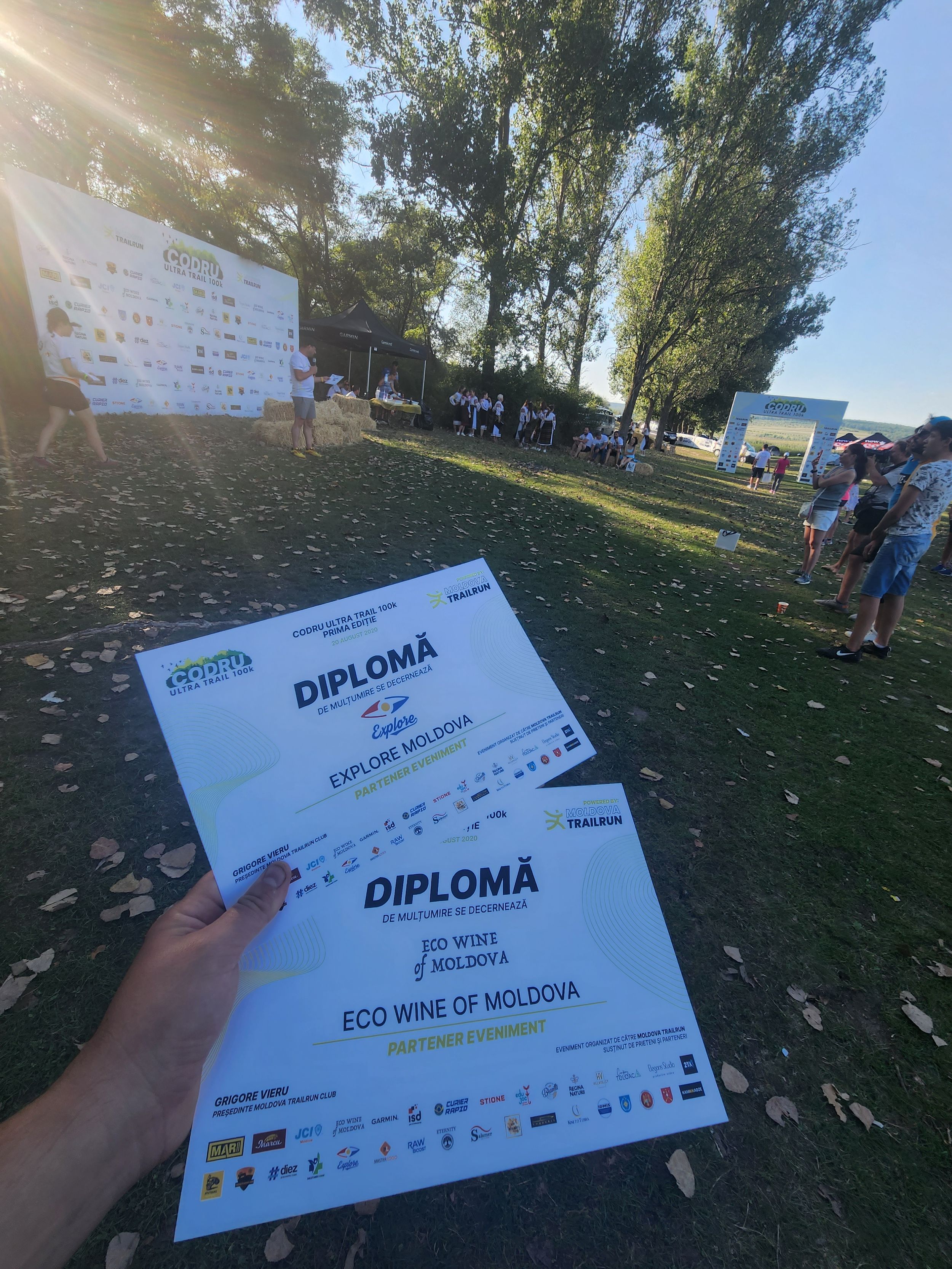 Two diplomas held up at Codru Ultra Trail event recognizing Explore Moldova and Eco Wine of Moldova.