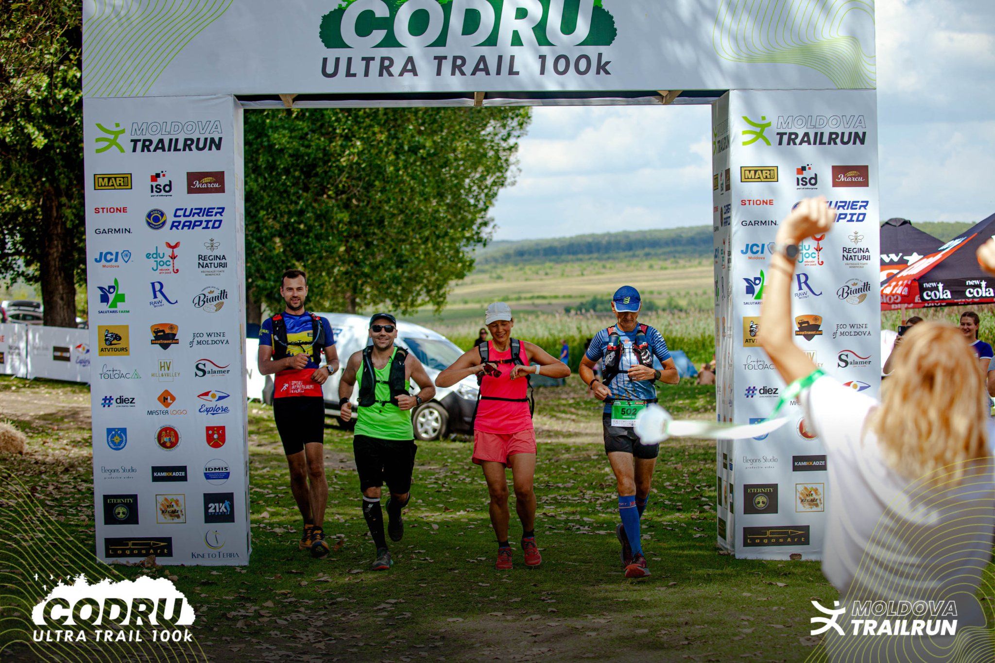 Runners crossing finish line together at Codru Ultra Trail 100k trail running race event.