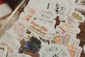 Assortment of whimsical book-themed stickers with fun phrases displayed in a clear box.
