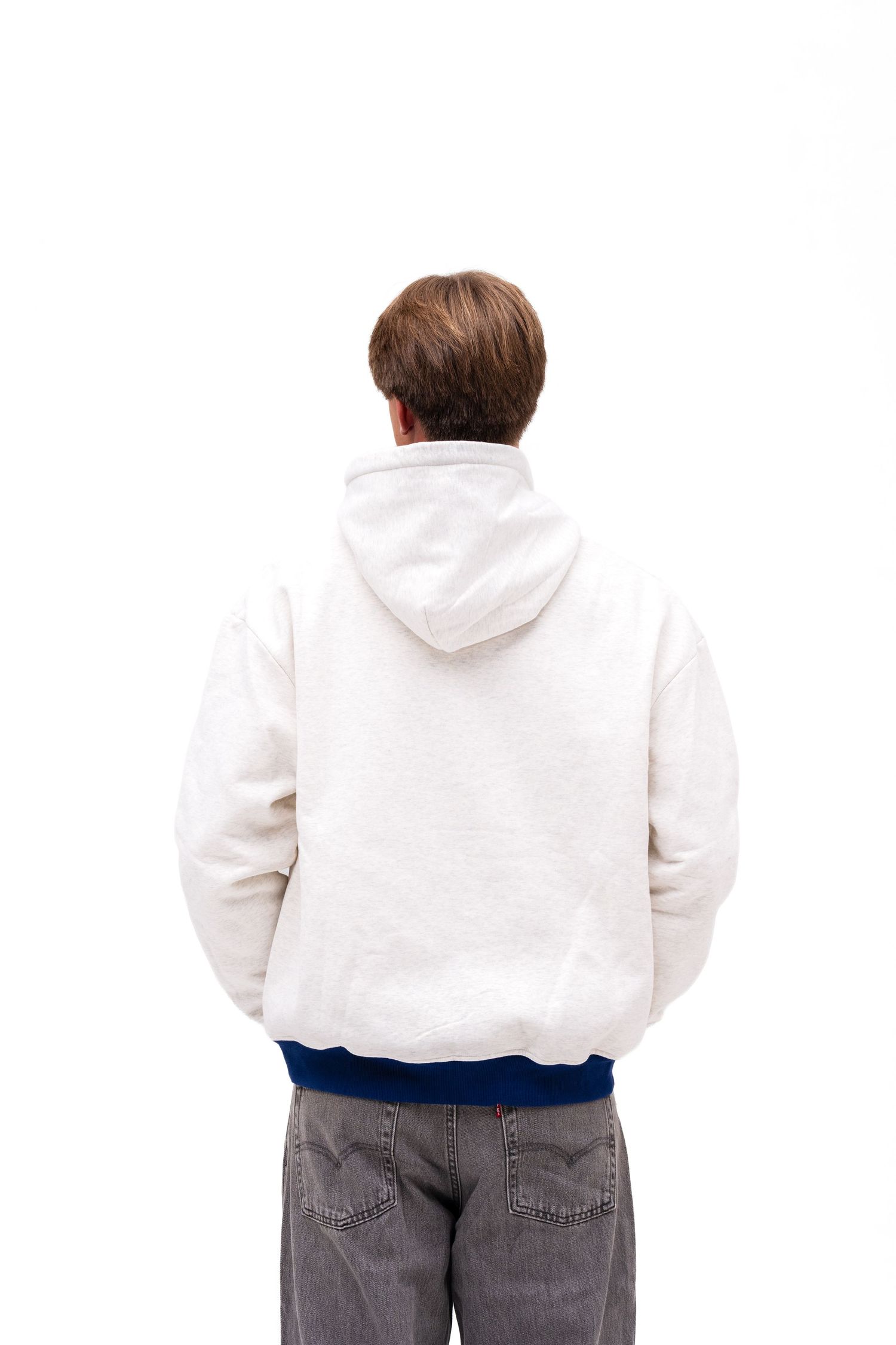 A white male model models an off-white hoodie with blue cuffs with the text "FIJI" on the front. A hoodie from The Hang Loose Hut.