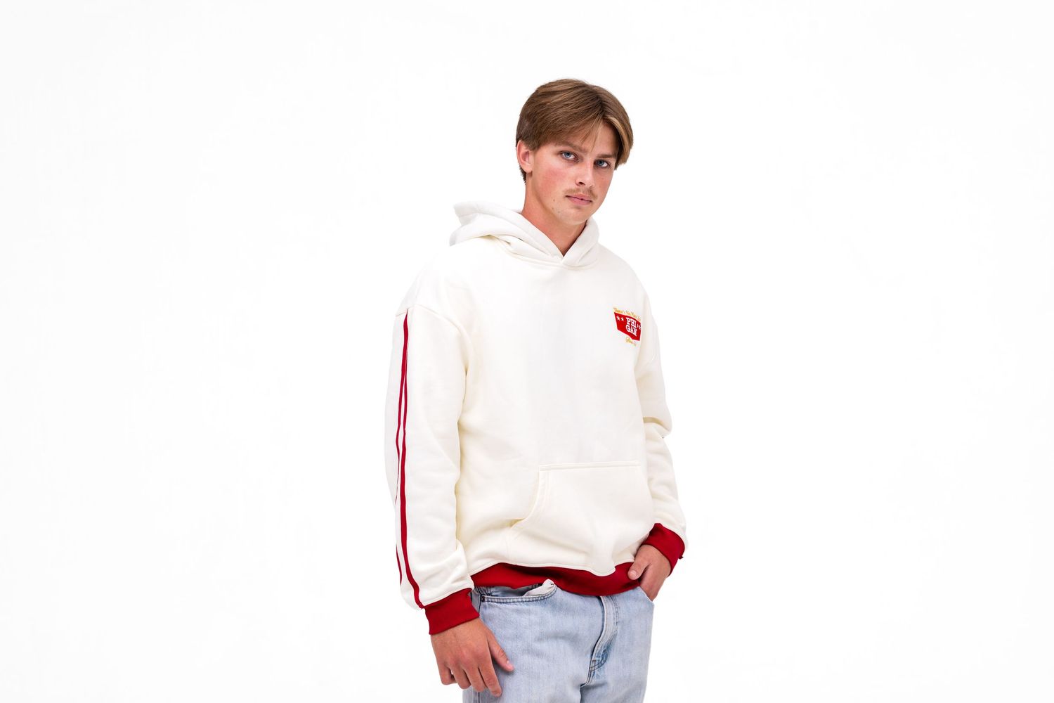 A white male model wears a light cream-colored hoodie with red cuffs with the text "PHI GAM" on the front. A hoodie from The Hang Loose Hut.