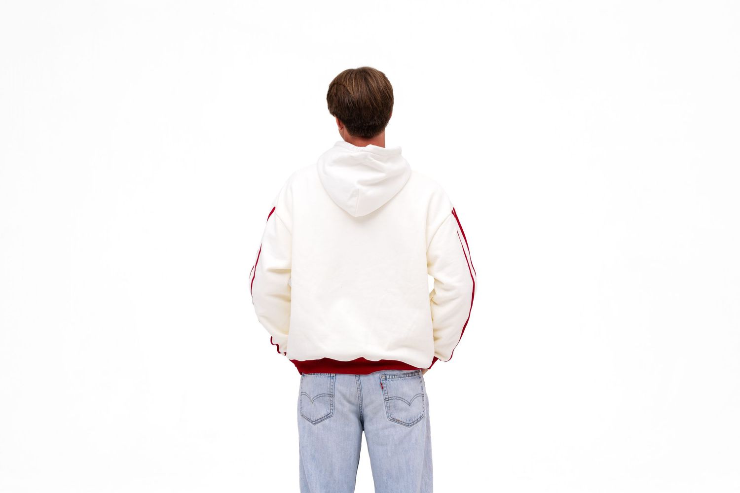 A white male model wears a light cream-colored hoodie with red cuffs with the text "PHI GAM" on the front. A hoodie from The Hang Loose Hut.