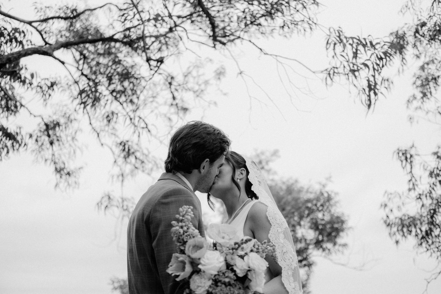 An intimate moment captured in black and white with a bouquet of flowers.