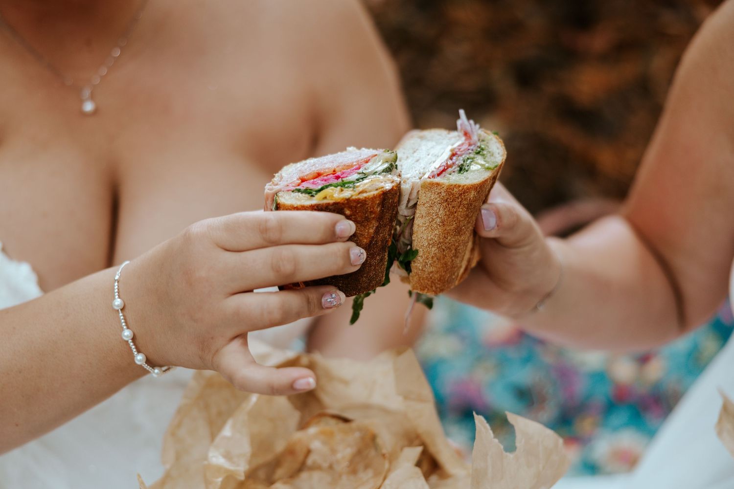 couple cheersing their sandwiches in golden gate park on their SF elopement day