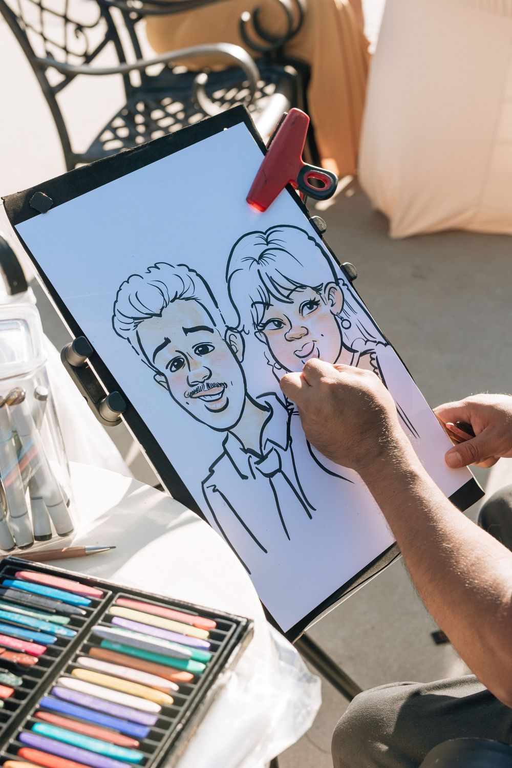 Caricature artist draws bride and groom at funky alternative los angeles wedding.