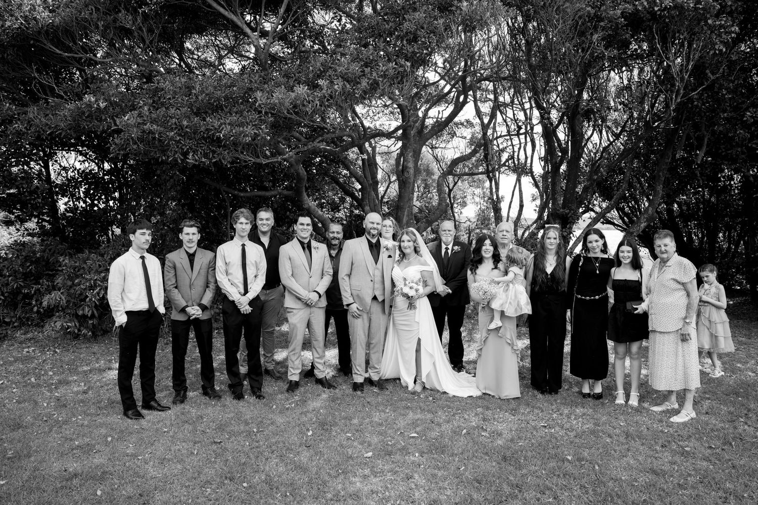 Black and white group photo of the couple with close family and friends - small elopement with a few guests