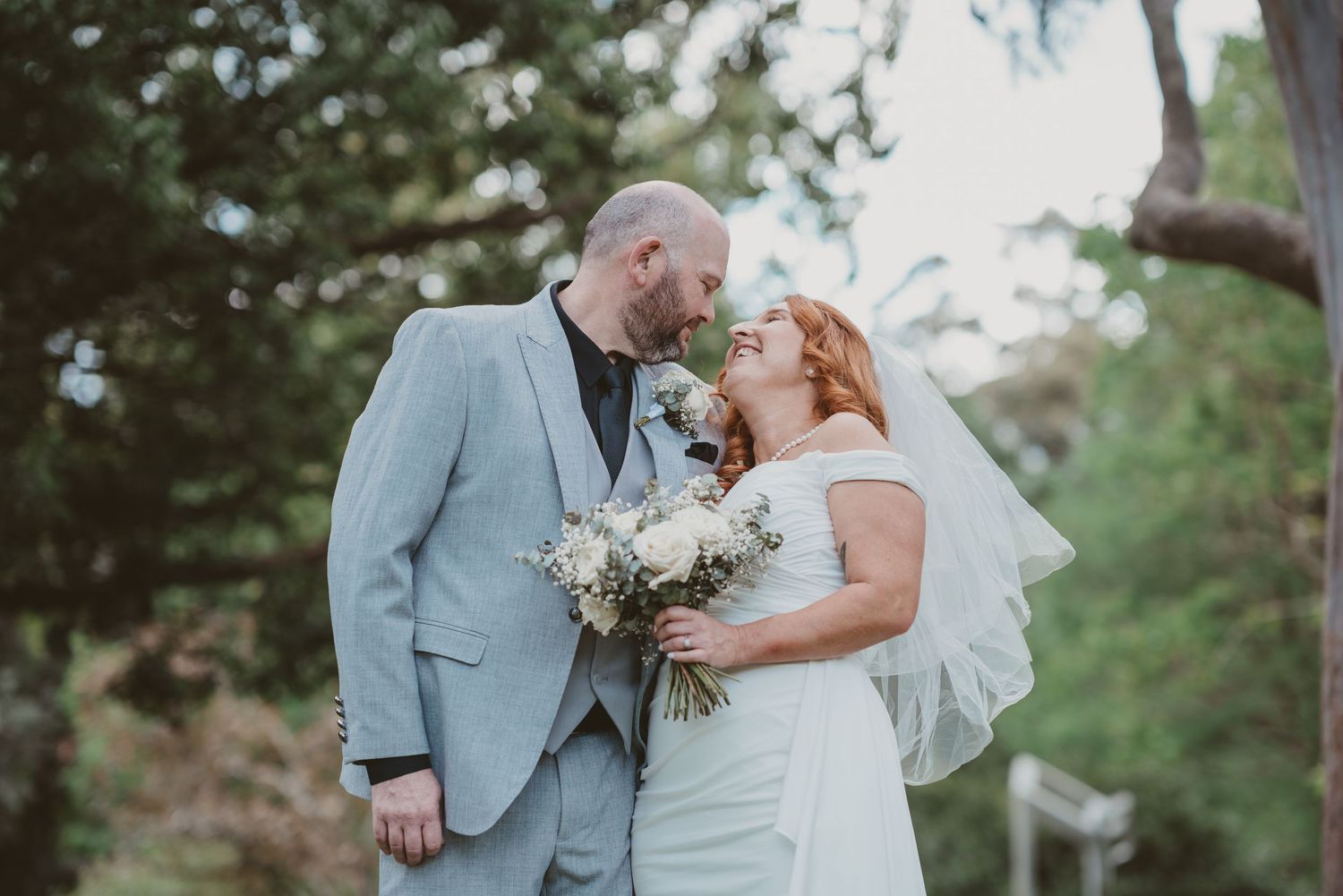 Bride and groom walk hand in hand through the garden - natural elopement couple photography