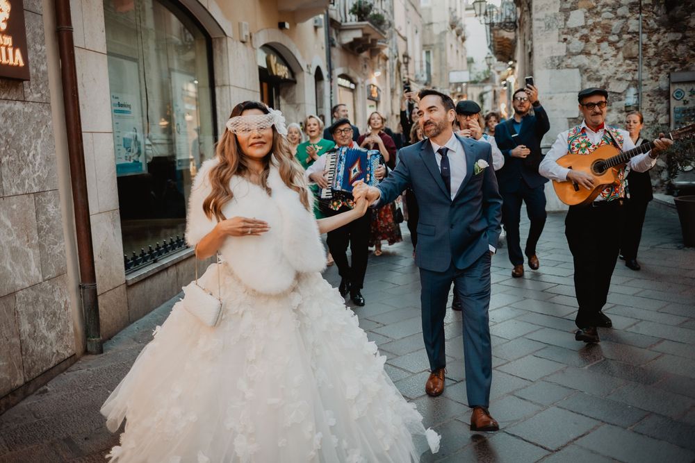Traditional Sicilian folk musicians celebrating a vow renewal in Piazza Duomo Taormina