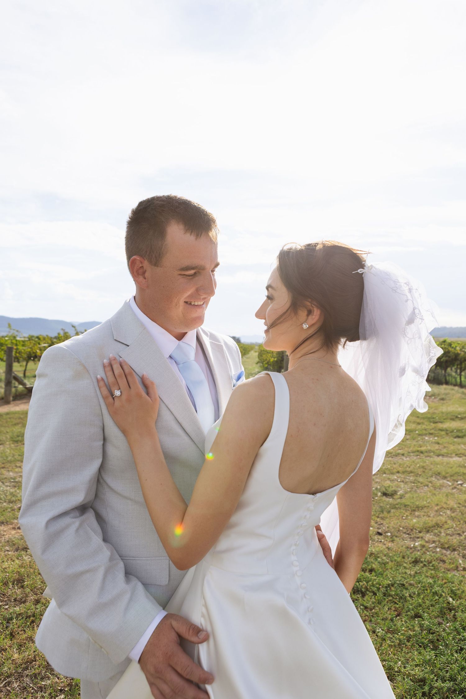 Bride and groom smiling at eachother  at Two Rivers Winery Wedding in Denman