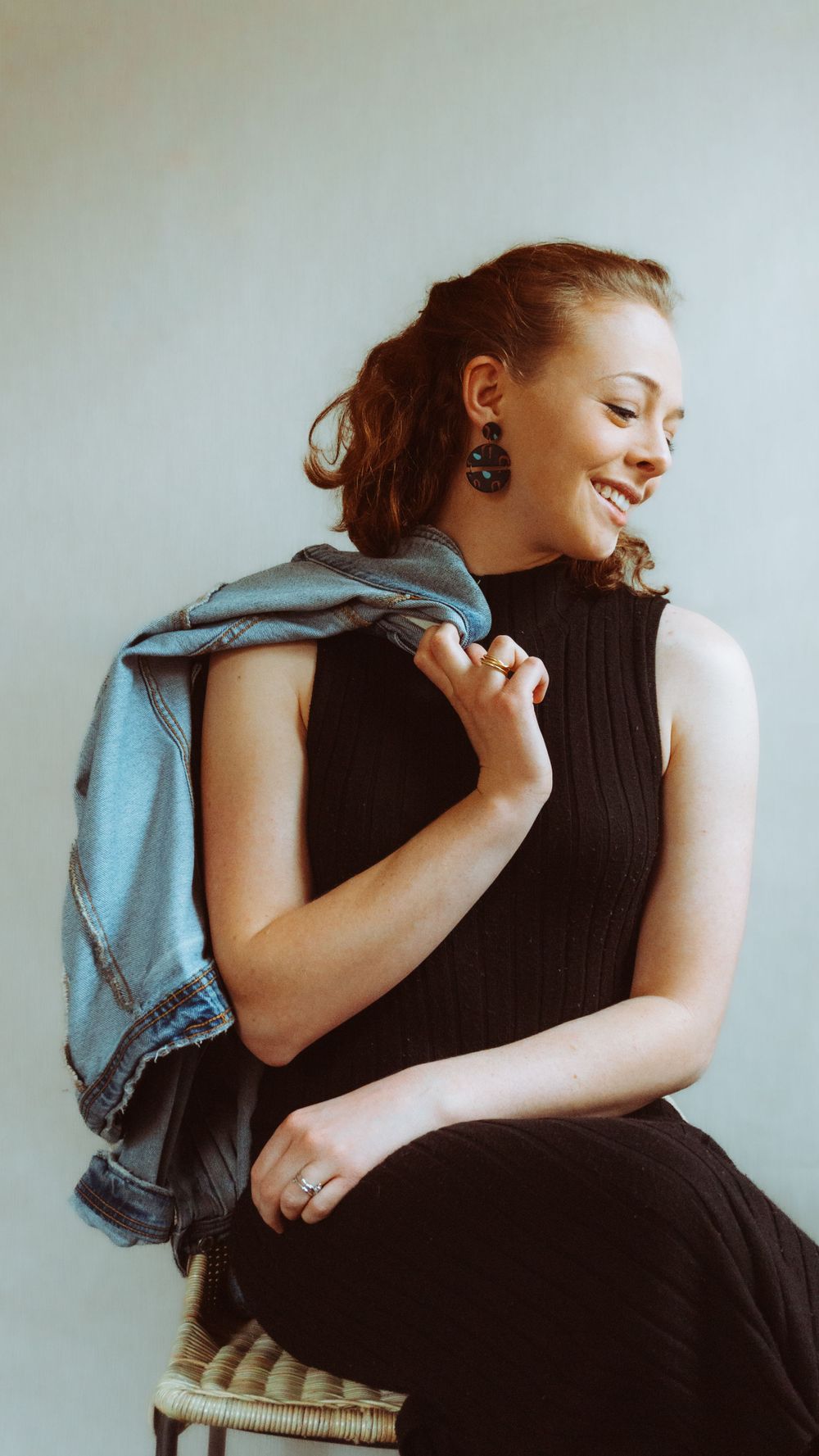 Expressive portrait series showing joyful movements while wearing a black sleeveless top.