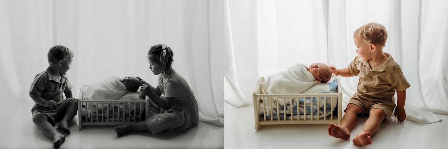 Sibling newborn photo session with toddler boy sitting beside baby in white crib, shown in black and white and color.