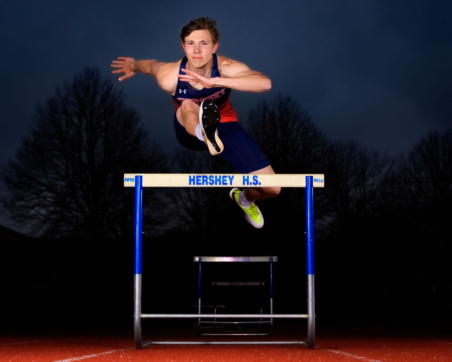 Hershey Trojans hurdling dramatic photo, by Deanna Fox, SportsFox Photography, Hershey PA