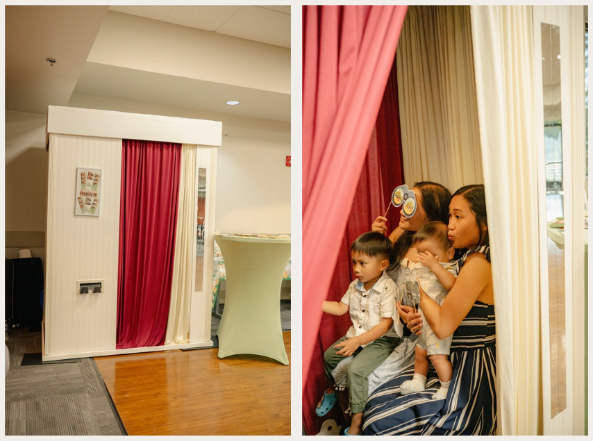 Classic photo booth with red and cream curtains on hardwood floor in an event venue.
