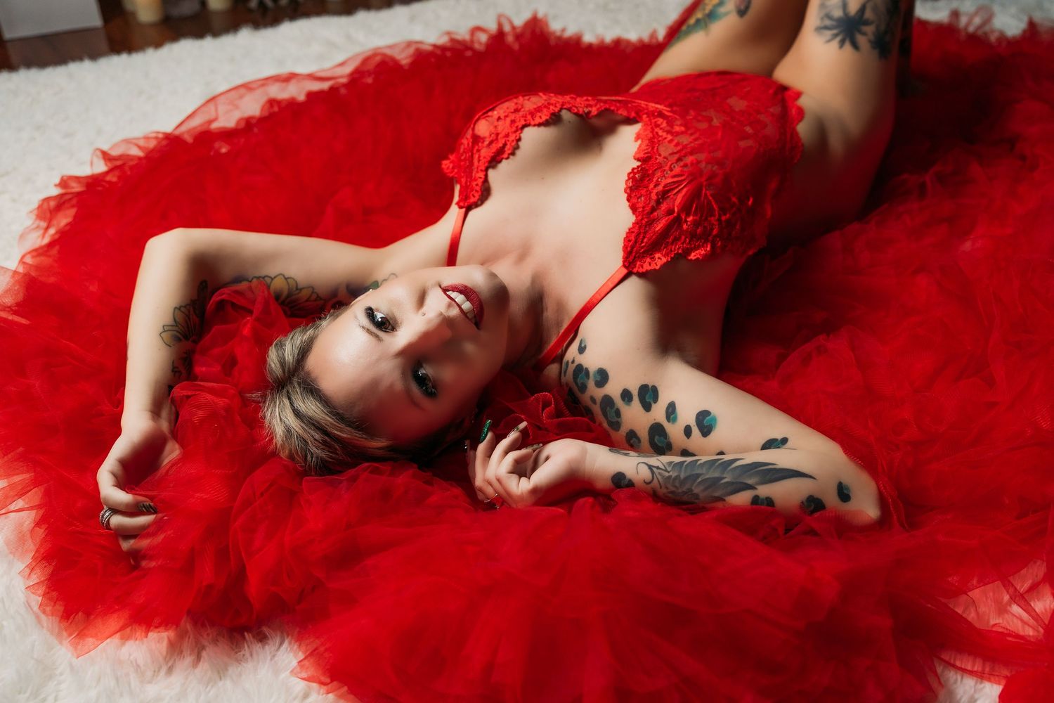 Blonde woman with tattoos in red and red tulle