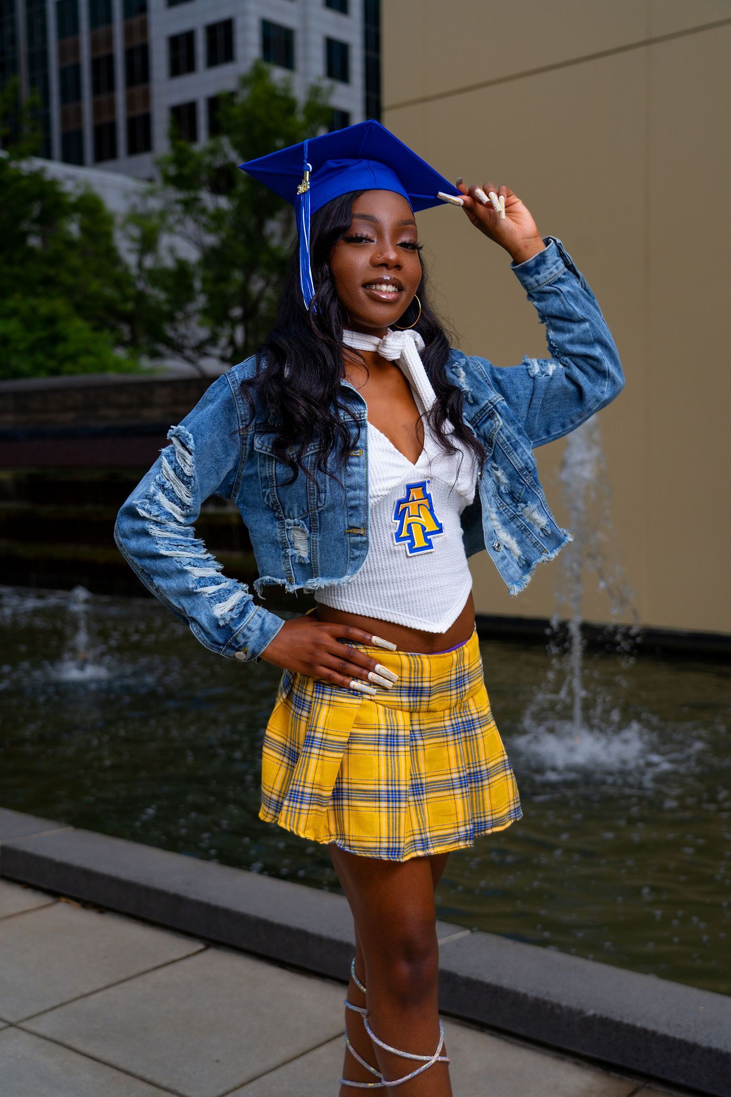 Stylish outfit featuring a yellow plaid skirt, denim jacket and white top captured in an outdoor photoshoot series.