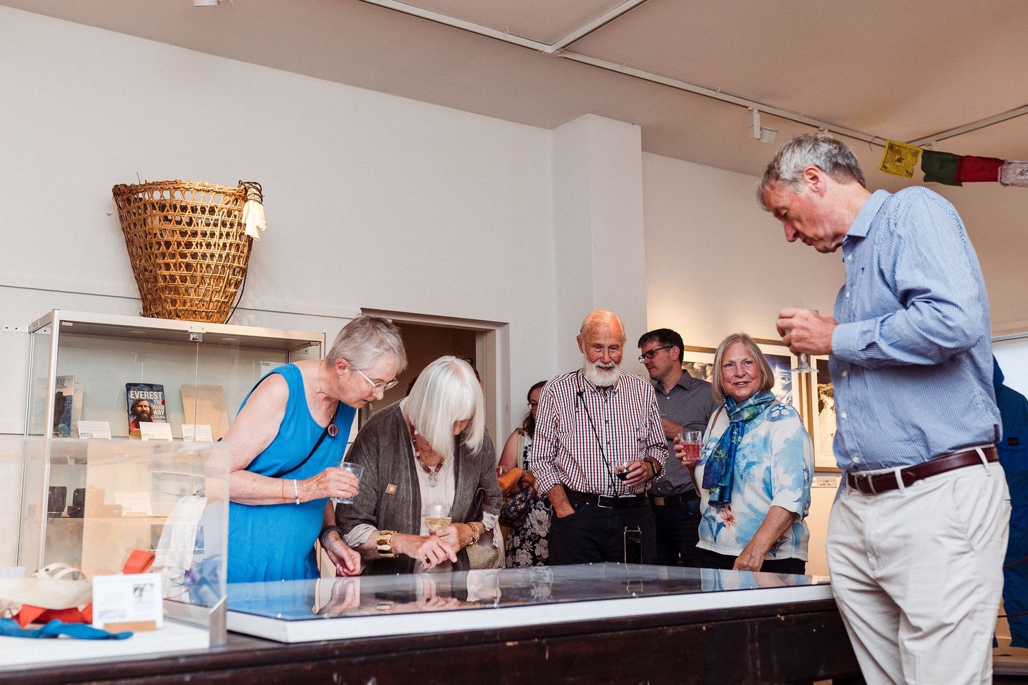 Seniors gathered around tables in a community center playing games and socializing during a recreational activity.