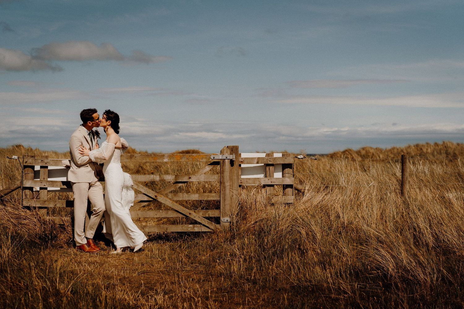 Intimate wedding portrait of a bride and groom sharing a tender moment in formal attire.