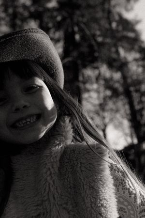 Black and white close-up portrait of someone wearing a cozy sherpa fleece jacket.
